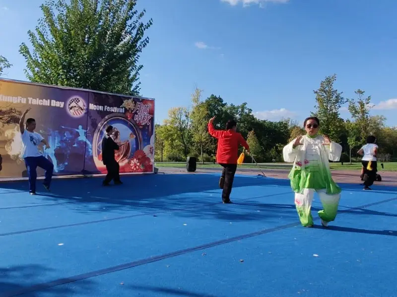 Kids & Adults tai chi participants kicking pads during stress-relief workout session